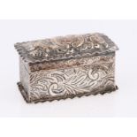 A Victorian silver stamp box, with repousse scroll design and interior having two compartments,