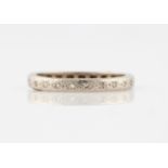 A diamond full eternity ring, set with eight cut diamond accents, unmarked white metal, ring size