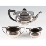 A three piece silver tea set, comprising a teapot, a milk jug and a sugar bowl, all hallmarked