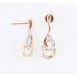 A pair of 9ct tri-gold diamond earrings, the open metalwork design set with round brilliant cut