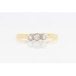 An 18ct yellow gold three stone diamond ring, set with three graduated round brilliant diamonds,