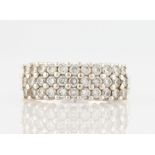 A three row diamond ring, set with round brilliant cut diamonds, each measuring approx. 0.03/0.04ct,