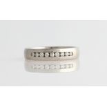 A gents palladium diamond set wedding band, channel set with nine round brilliant cut diamonds,