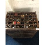 A stained wood seven drawer storage chest containing tools etc.