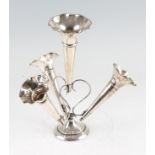 An early 20th Century silver epergne, with central larger trumpet and three smaller trumpets, raised