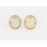 A pair of 9ct yellow gold opal stud earrings, each set with an oval opal cabochon, measuring approx.