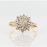 An 18ct yellow gold diamond cluster ring, the tiered design set with graduated round brilliant cut