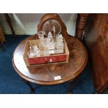 A circular veneered coffee table, oak cased mantle clock, a pair of glass candlesticks and two