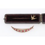 A split pearl and red paste crescent brooch, together with a seed pearl set swallow stick pin, (2).