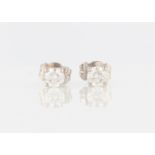 A pair of 18ct white gold diamond stud earrings, each set with a round brilliant cut diamond,