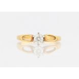 An 18ct yellow gold diamond solitaire ring, set with a round brilliant cut diamond, measuring