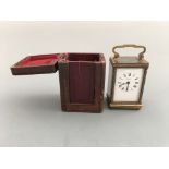 A Cooper & Co. Worcester miniature carriage clock in leather case. Height 12.5cm.