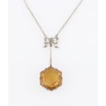 A citrine and diamond necklet, set with a hexagonal cut citrine, suspended from tapered metalwork,