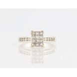 A 18ct white gold diamond cluster ring, the square head set with twelve princess cut diamonds, the