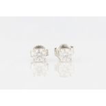 A pair of 9ct white gold diamond stud earrings, each set with a round brilliant cut diamond,