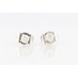 A pair of 18ct white gold diamond stud earrings, each set with a round brilliant cut diamond,