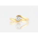 An 18ct yellow gold diamond solitaire ring, set with a round brilliant cut diamond, measuring