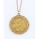 A Mohur token medallion, mounted in an open metalwork pendant mount, indistinctly stamped, on a