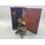 A mahogany cased brass travel microscope, by J.Swift & Son London with various lenses.