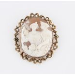 A cameo brooch, depicting two ladies and child, set in unmarked yellow metal open metalwork frame,