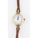 A ladies 15ct yellow gold wrist watch, the white enamel dial having hourly Arabic numerals with