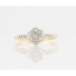A diamond flower design ring, set with eight-cut diamonds in flower pattern with additional