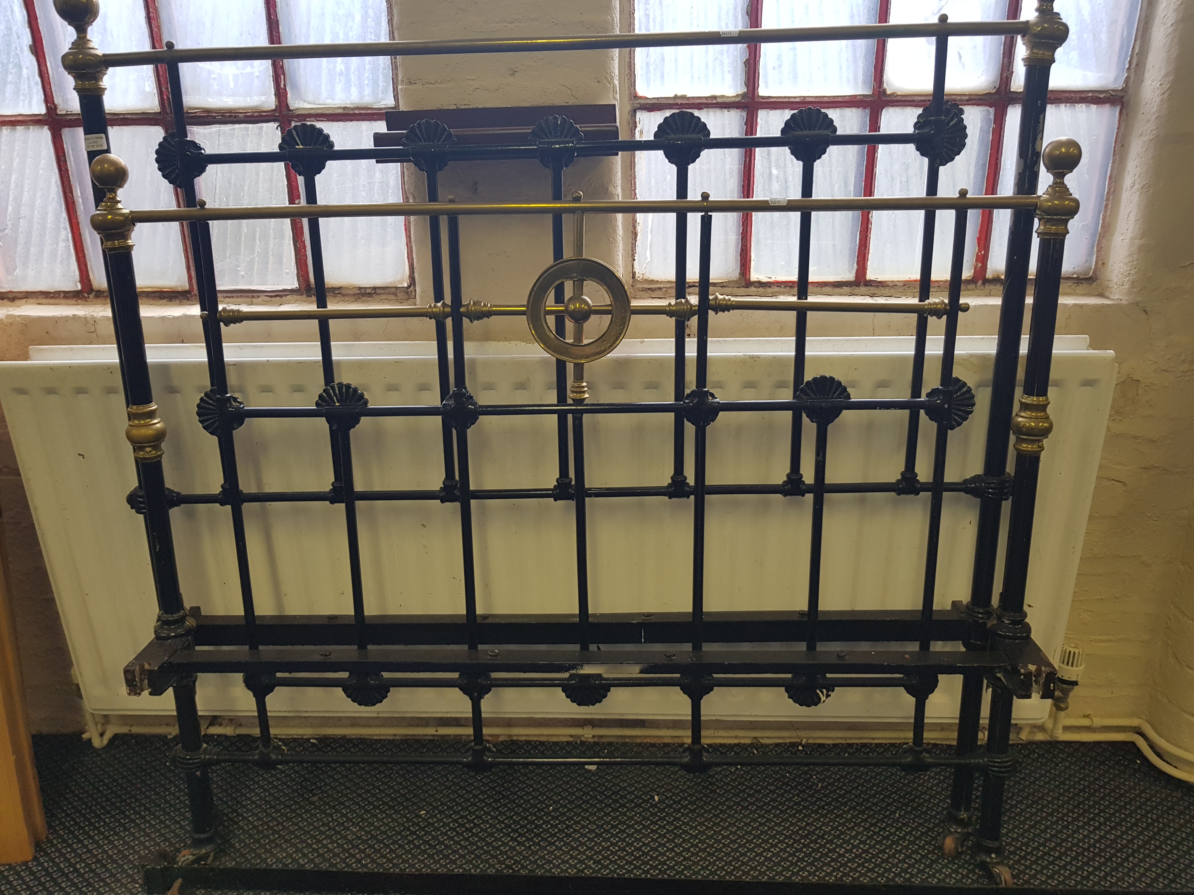 A Victorian brass and iron double bed.