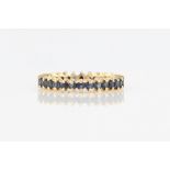 A sapphire full eternity ring, set with round cut sapphires, stamped 9k, ring size L½.