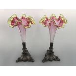 A pair of cranberry and uranium rim glass trumpet vases with pewter bases. Height 35cm.