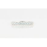 A hallmarked 9ct white gold aquamarine half eternity ring, set with nine round cut aquamarines, ring