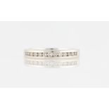 An 18ct white gold diamond half eternity ring, channel set with thirteen round brilliant cut