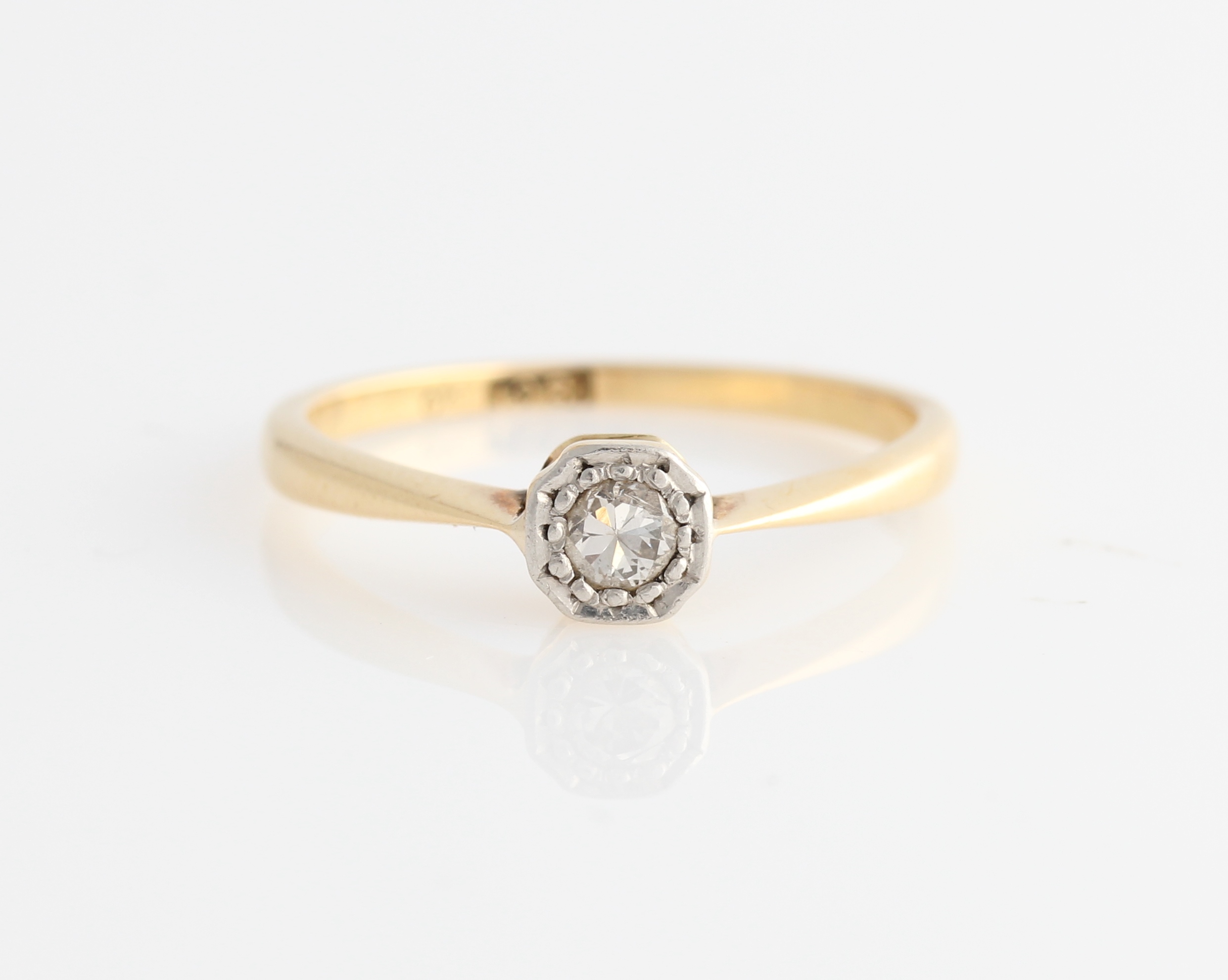 A diamond solitaire ring, set with a round brilliant cut diamond, measuring approx. 0.15ct,