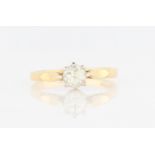 An 18ct yellow gold diamond solitaire ring, set with a round brilliant cut diamond, measuring