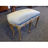 A French late 19th century eight legged stool gilt with dusty blue upholstery.