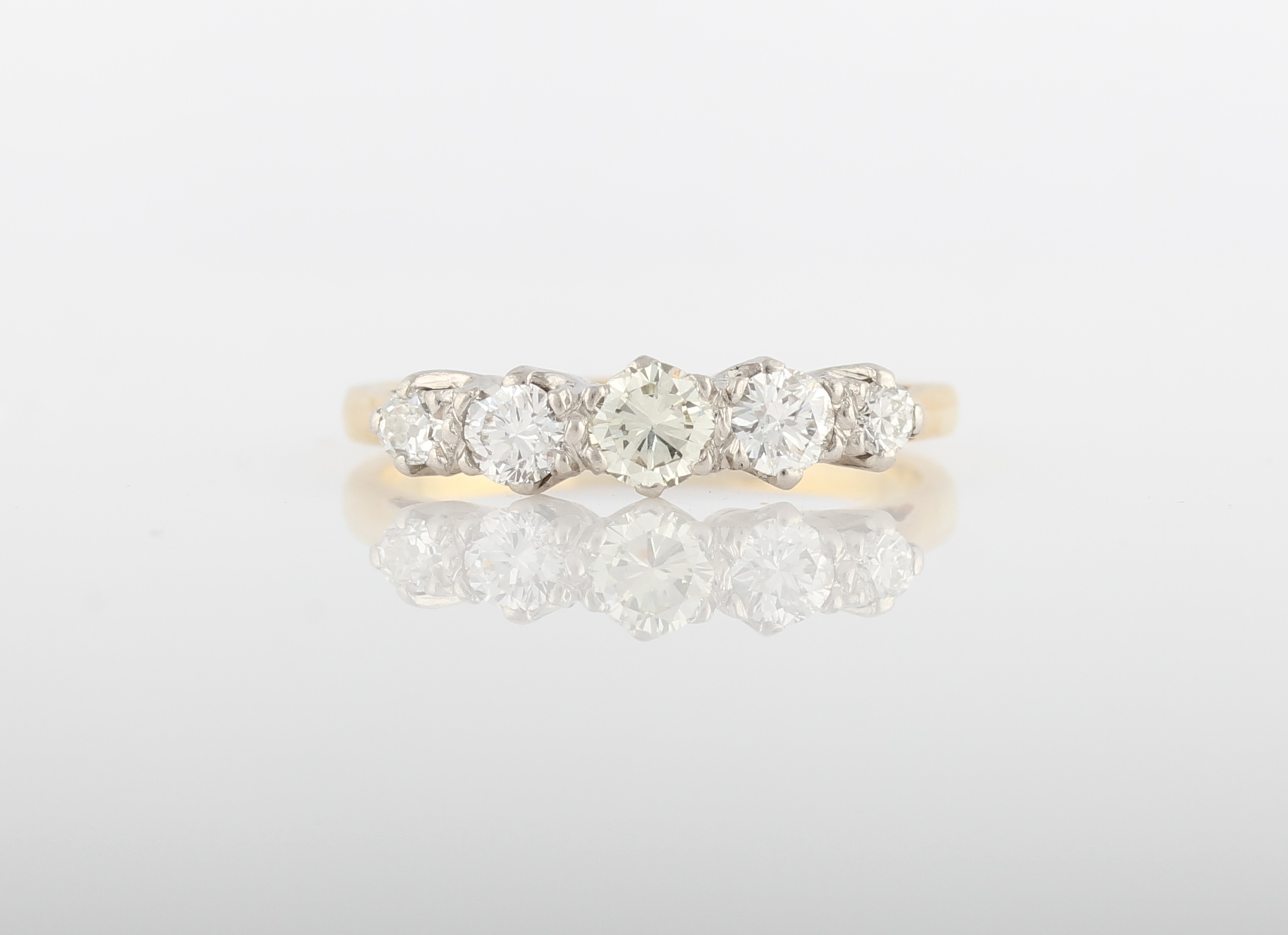 A five stone diamond ring, set with five graduated round brilliant cut diamonds, total diamond
