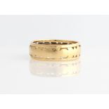 A hallmarked 18ct yellow gold open metalwork wedding band.