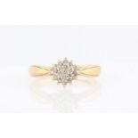 A hallmarked 9ct yellow gold diamond cluster ring, set with eight cut diamonds in three tiers,