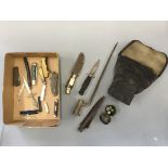 A gas mask in case, bayonet, various daggers with sheaths, small compasses, pen knives, razor.