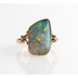 An 18ct yellow old opal ring set with an irregular piece of opal, measures approx. 10x17mm, with