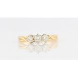 An 18ct yellow gold three stone diamond ring, set with three graduated round brilliant cut diamonds,