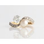 A diamond and pearl ring, set principally with an Old European cut diamond, measuring approx. 0.