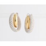 A pair of diamond set hoop stud earrings, each earring designed as two crossing hoops, the inner