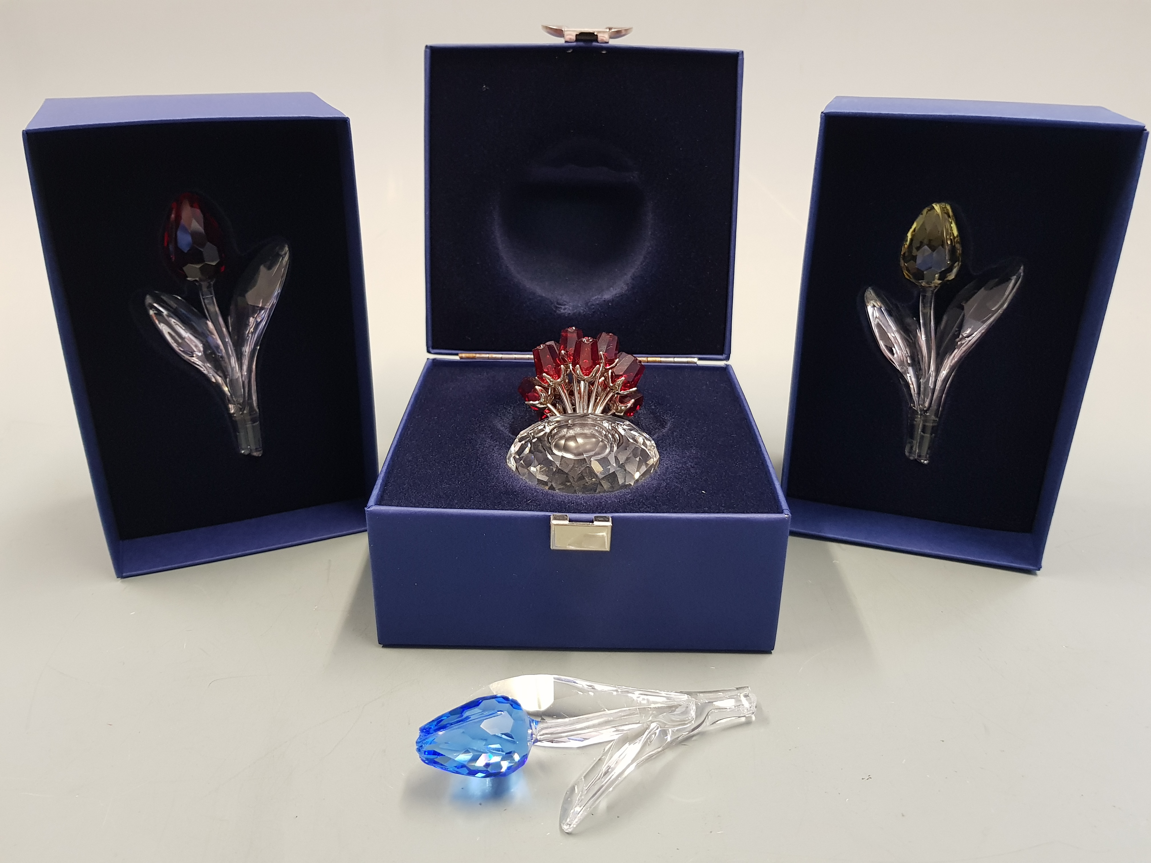 Four boxed Swarovski coloured glass items, vase of flowers with Certificate and three single