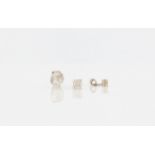 A pair of diamond stud earrings, each set with a round brilliant cut diamond, measuring approx. 0.