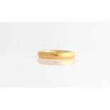 A hallmarked 22ct yellow gold plain wedding band.