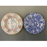 Two tin glazed plates, one with Dutch and one with Chinese design. Diameters approximately 35cm.