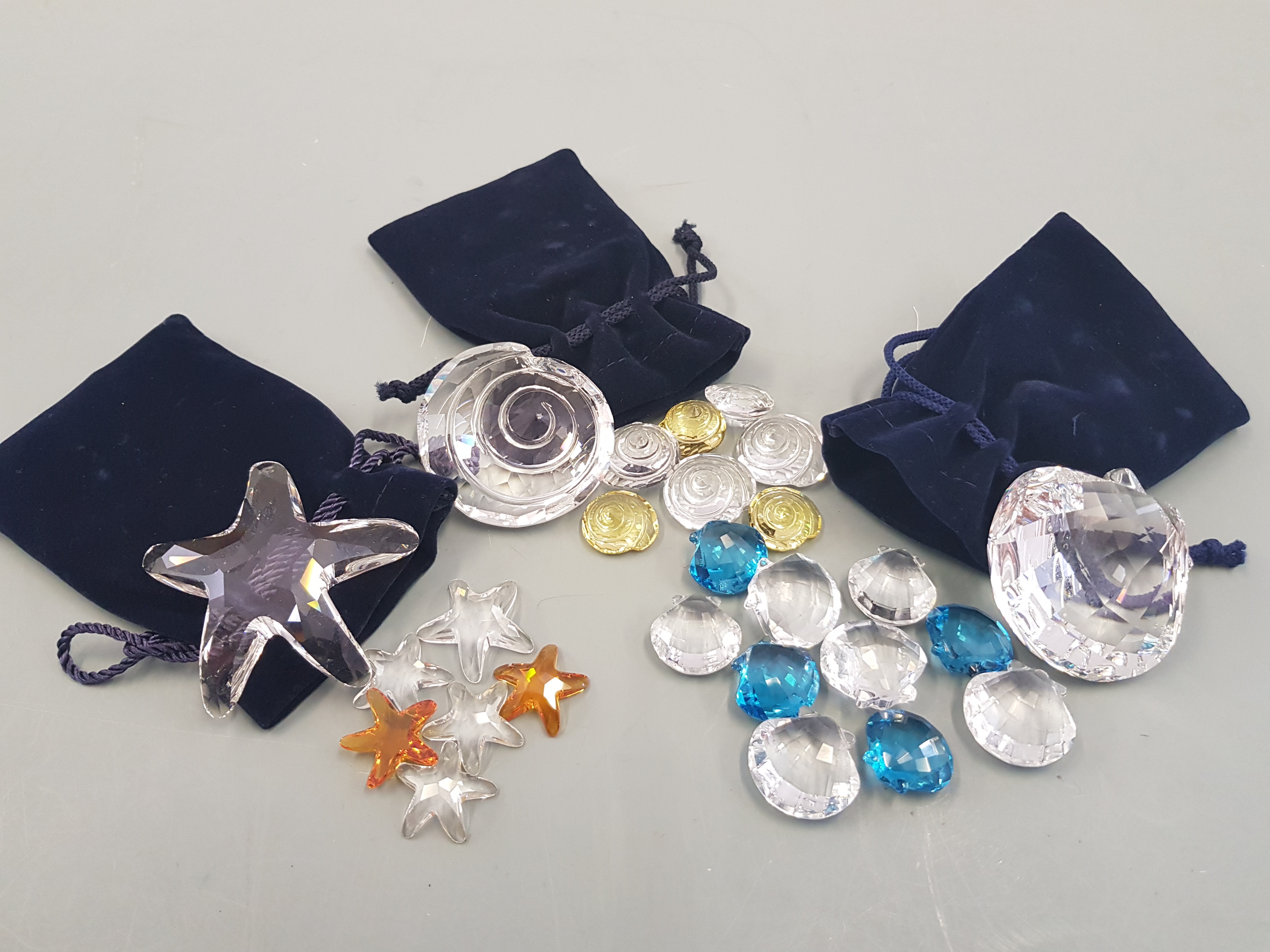 Six boxed Swarovski crystal items, Star fish, clams shells.