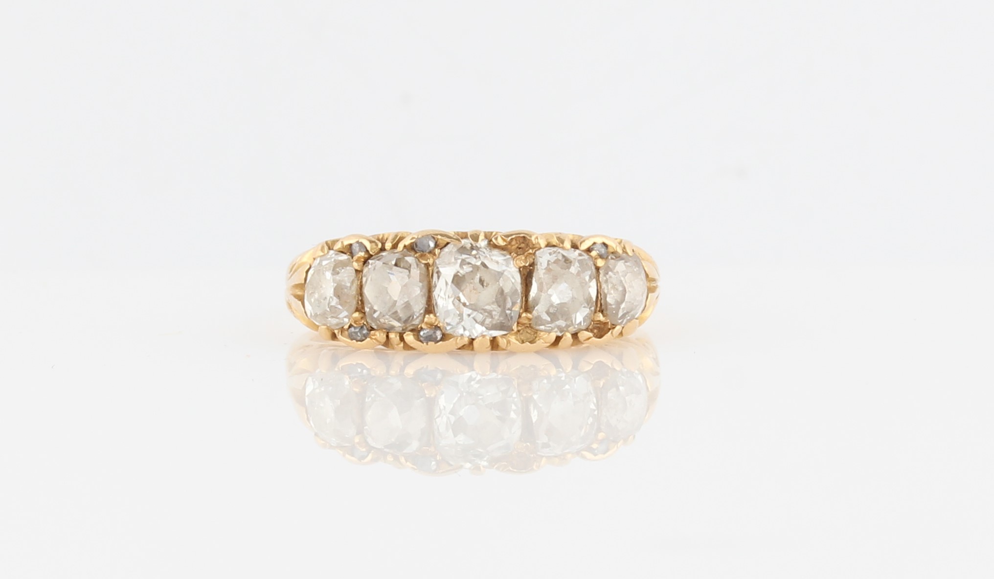 A late 19th/early 20th Century diamond ring, set with five principal graduated old cut diamonds,