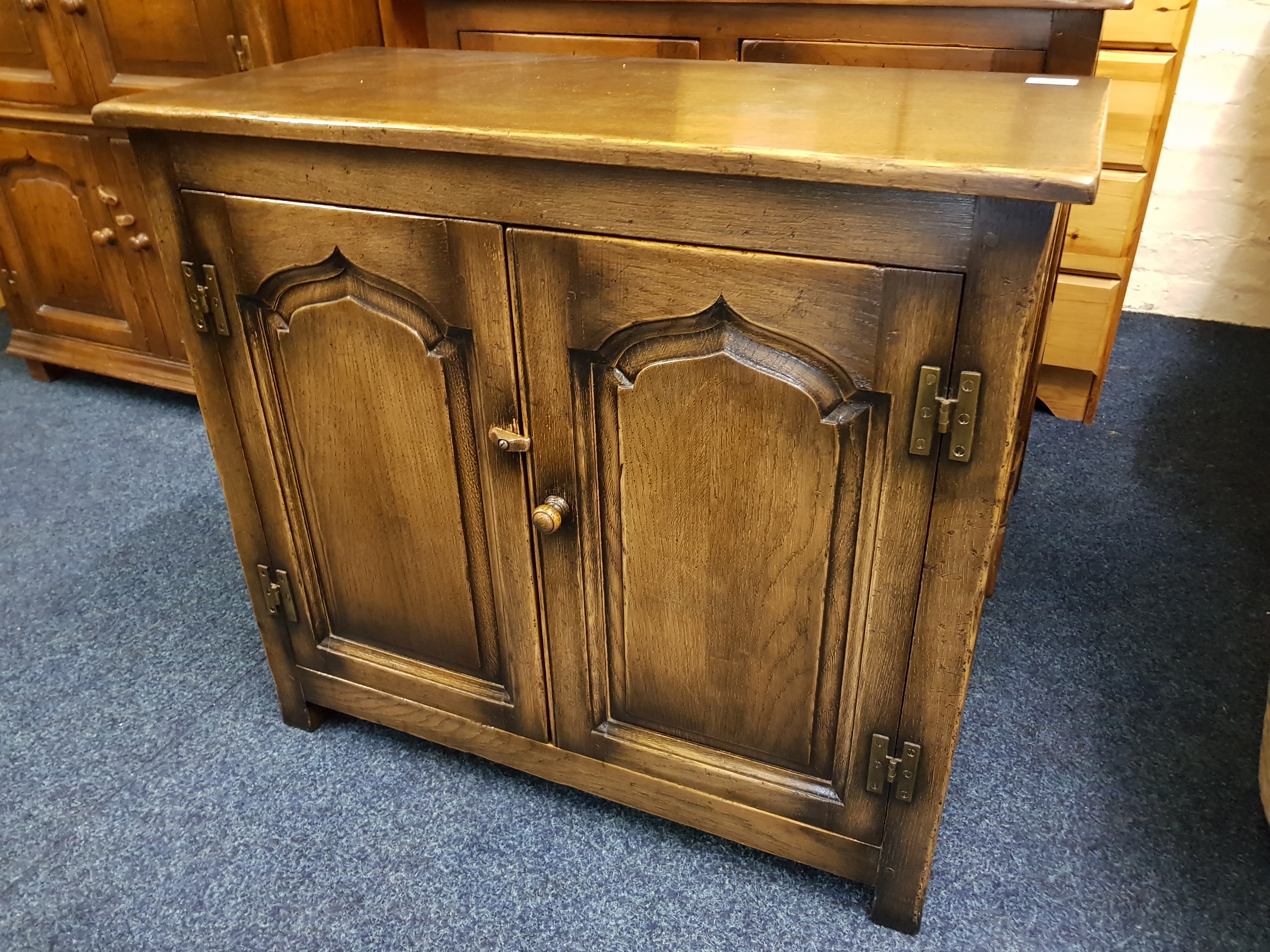 A reproduction distressed oak two door cupboard.