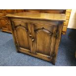 A reproduction distressed oak two door cupboard.